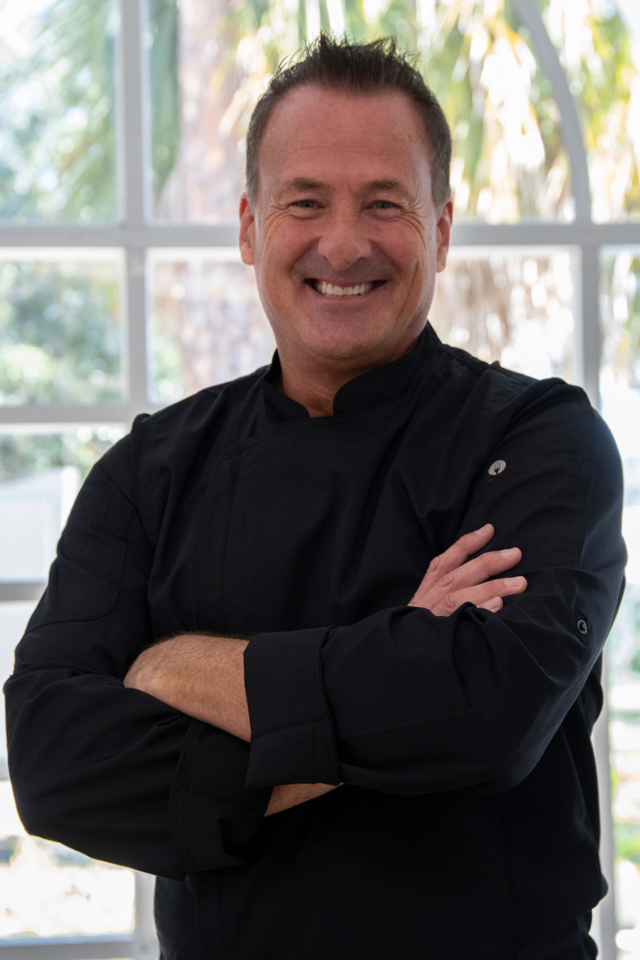 Michael smiling in his black chef jacket